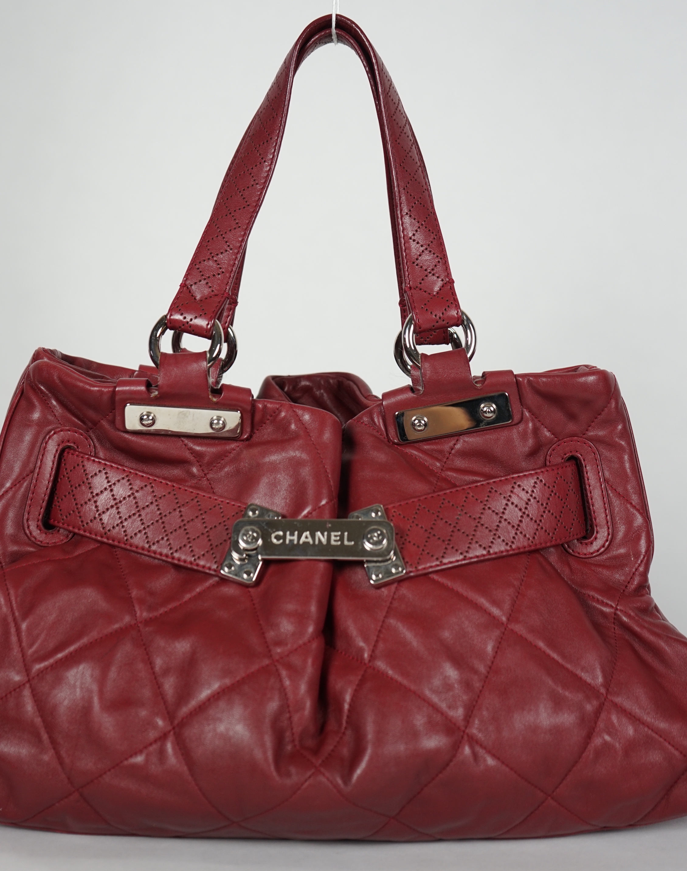 A Chanel burgundy leather buckled handle bag, with dust bag, width 45cm, height: 24.5cm, height overall 44cm, depth 16.5cm, Please note this lot attracts an additional import tax of 20% on the hammer price